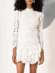 White floral lace mock neck mini dress with ruffled hem and long sleeves.