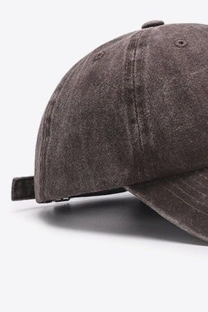 Washed cotton baseball cap in brown with adjustable strap detail.