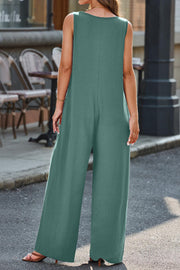 Flowing palazzo jumpsuit in matcha green with a V-neck and wide legs.