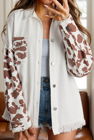 White cow print denim shacket with frayed edges and button front.