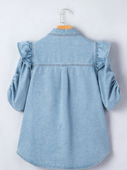 Light wash denim button-down shirt with ruffled shoulders and ruched sleeves.