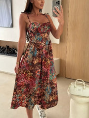 Floral tie-strap midi dress in brown with a colorful floral print, sweetheart neckline, and A-line skirt.
