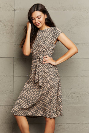 Geometric print midi dress in camel with tie waist and short sleeves.