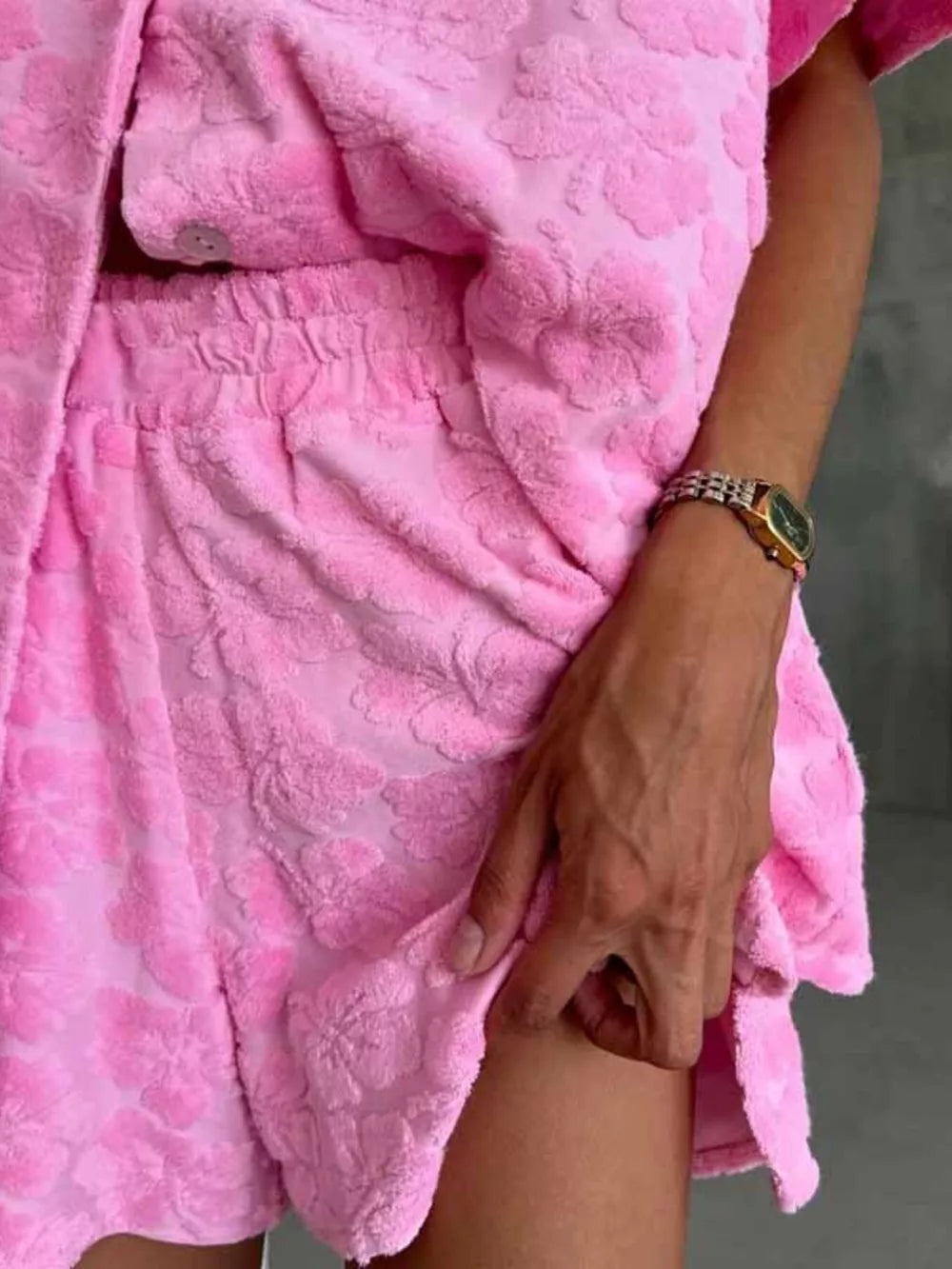 Pink textured floral button-up shirt and shorts set with elastic waist shorts.