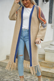 Khaki long cardigan with blue trim, geometric sleeve detail, and fringed hemline.