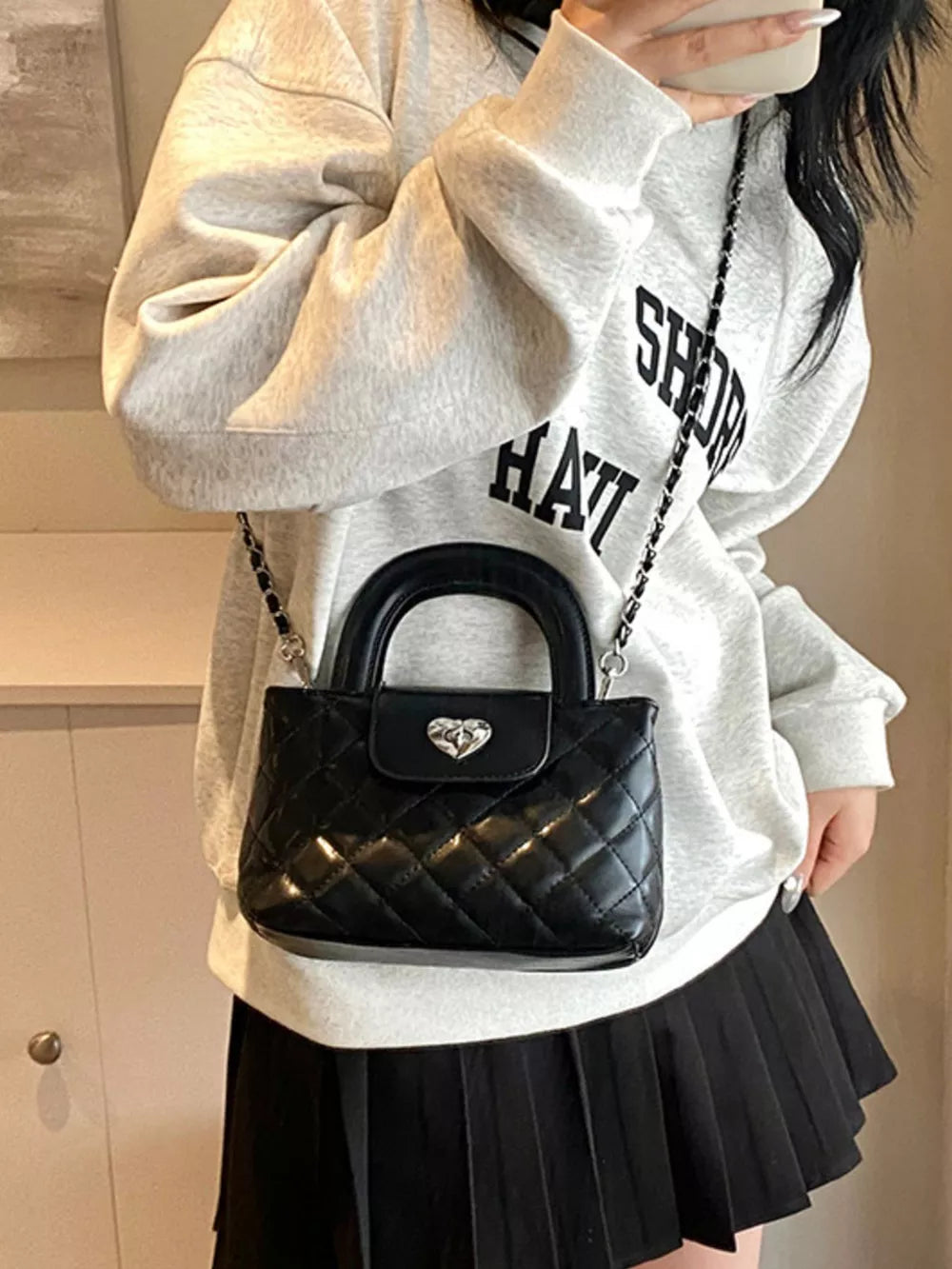 Quilted Heart Lock Crossbody Bag in Black, side view