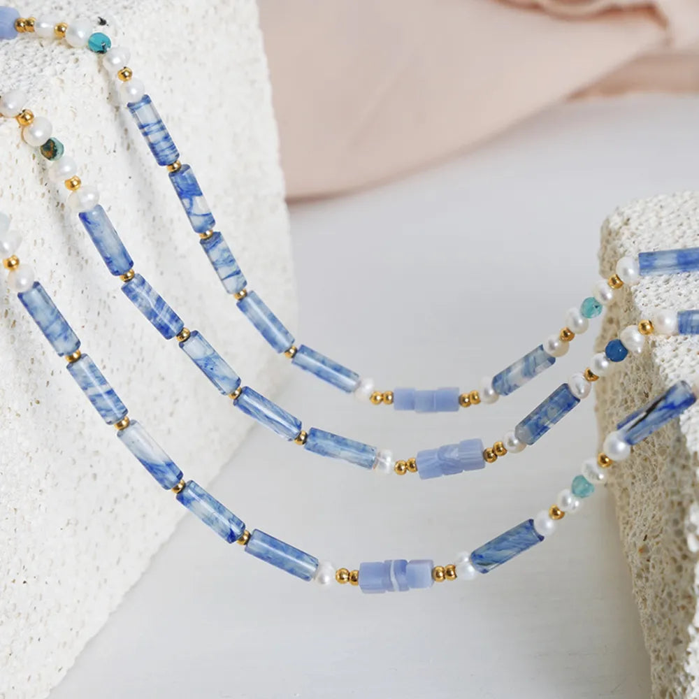 Lapis Lazuli & Pearl Bead Necklace with gold accents and light blue marbled beads.
