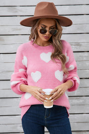 Pink fluffy knit sweater with white hearts and balloon sleeves.