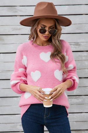 Pink fluffy knit sweater with white hearts and balloon sleeves.