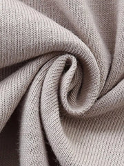 Close up of beige cotton knit fabric detail on a baby t-shirt.