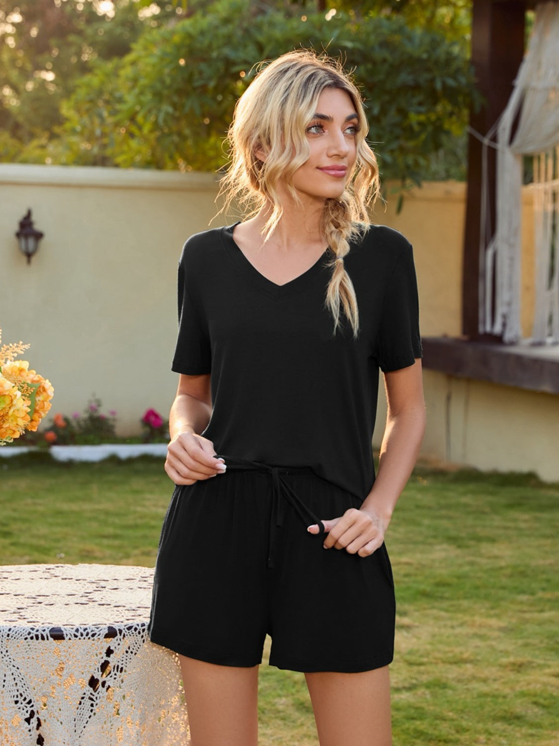 Black V-neck lounge set with shorts, featuring a relaxed fit and drawstring waist.