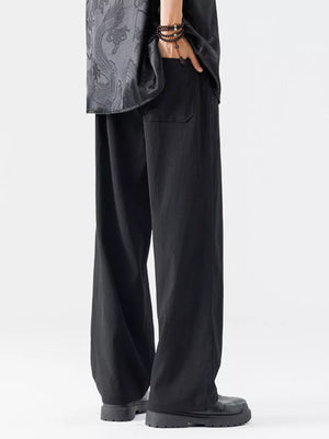 Black wide-leg men's sweatpants with embroidered detail on shirt