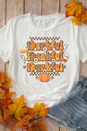 White graphic tee with "thankful" repeated in groovy font, pumpkin, pie, and coffee cup graphics.