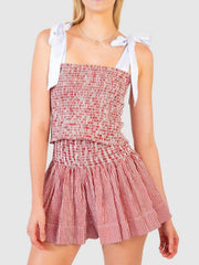 Smocked bodice and skirt set in strawberry red and white stripe seersucker with tie straps.