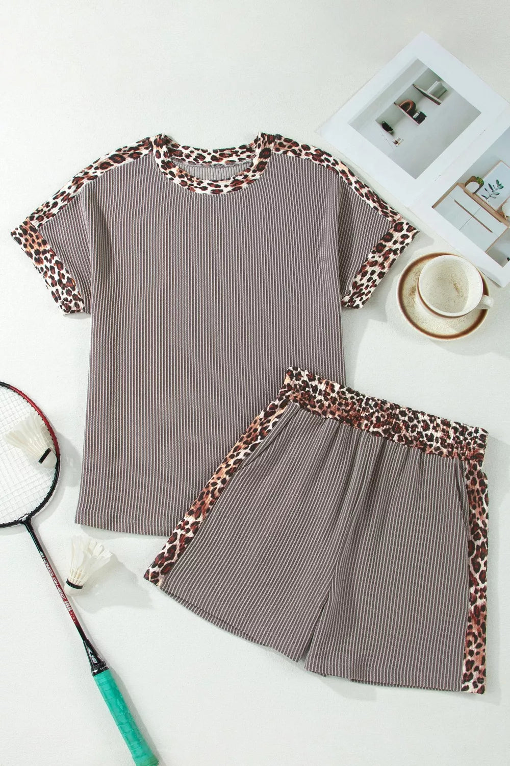 Brown ribbed knit two-piece set with leopard trim on neckline, sleeves, and shorts.