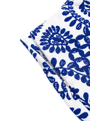Blue floral tie skort with white asymmetrical slit detail and zipper.