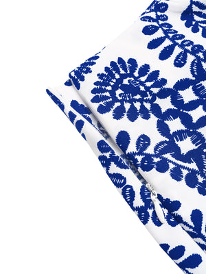 Blue floral tie skort with white asymmetrical slit detail and zipper.