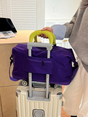 Vibrant purple travel bag with neon yellow handles and a front zippered pocket.