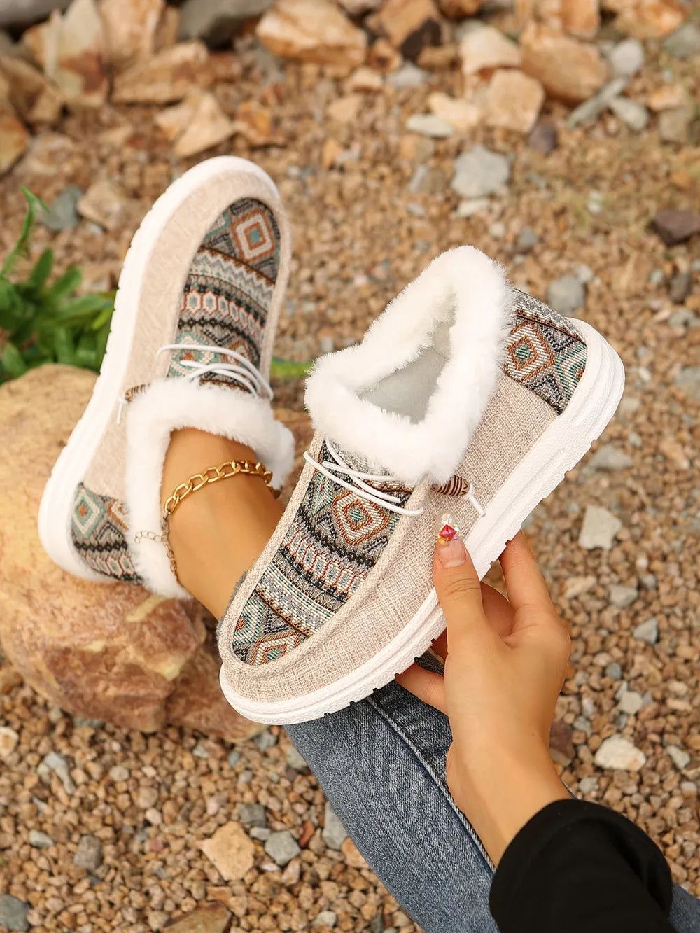 Southwestern print faux fur lined loafers in taupe with white laces and a gold ankle bracelet.