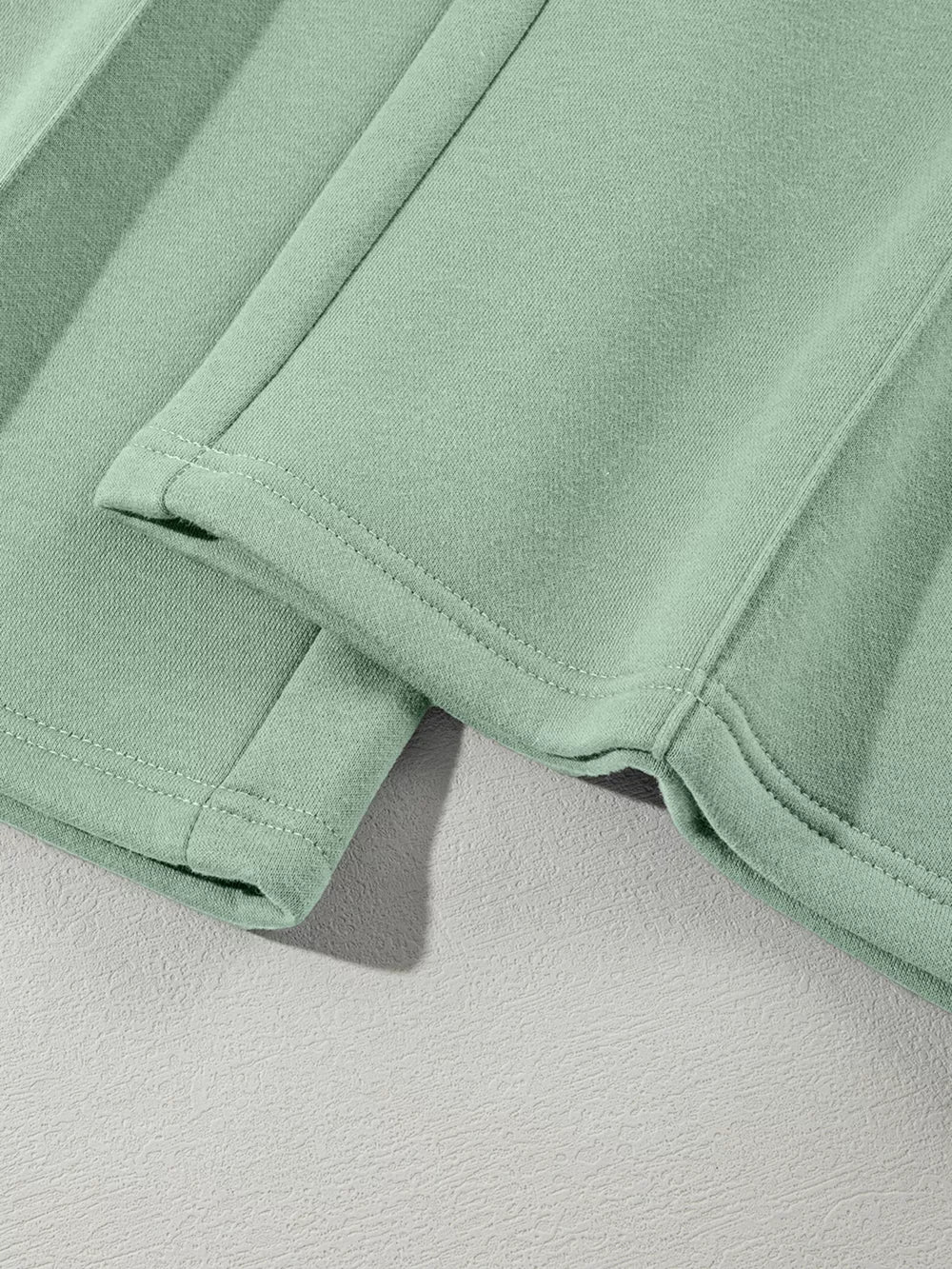 Sage cotton joggers with double-stitched hem detail and side seam.