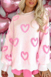 Pink knit sweater with heart appliqué and balloon sleeves.