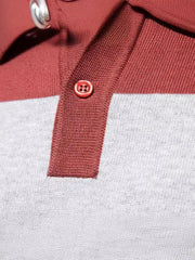 Colorblock knit polo shirt in burgundy and gray with ribbed collar and button detail.