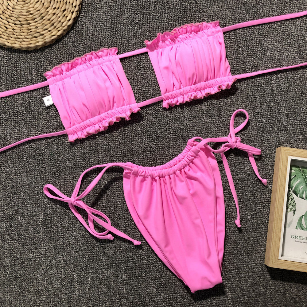 Pink ruffle bandeau bikini set with tie sides and ruched detail.