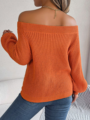 Pumpkin open-knit off-shoulder sweater with voluminous sleeves and ribbed texture.