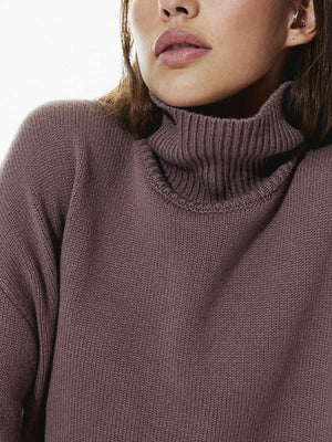 Dust Storm acrylic turtleneck sweater with ribbed collar and sculptural sleeves.