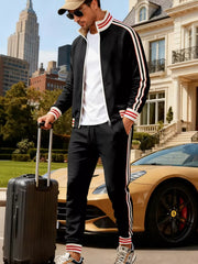 Black tracksuit with red and white stripes on sleeves and legs.