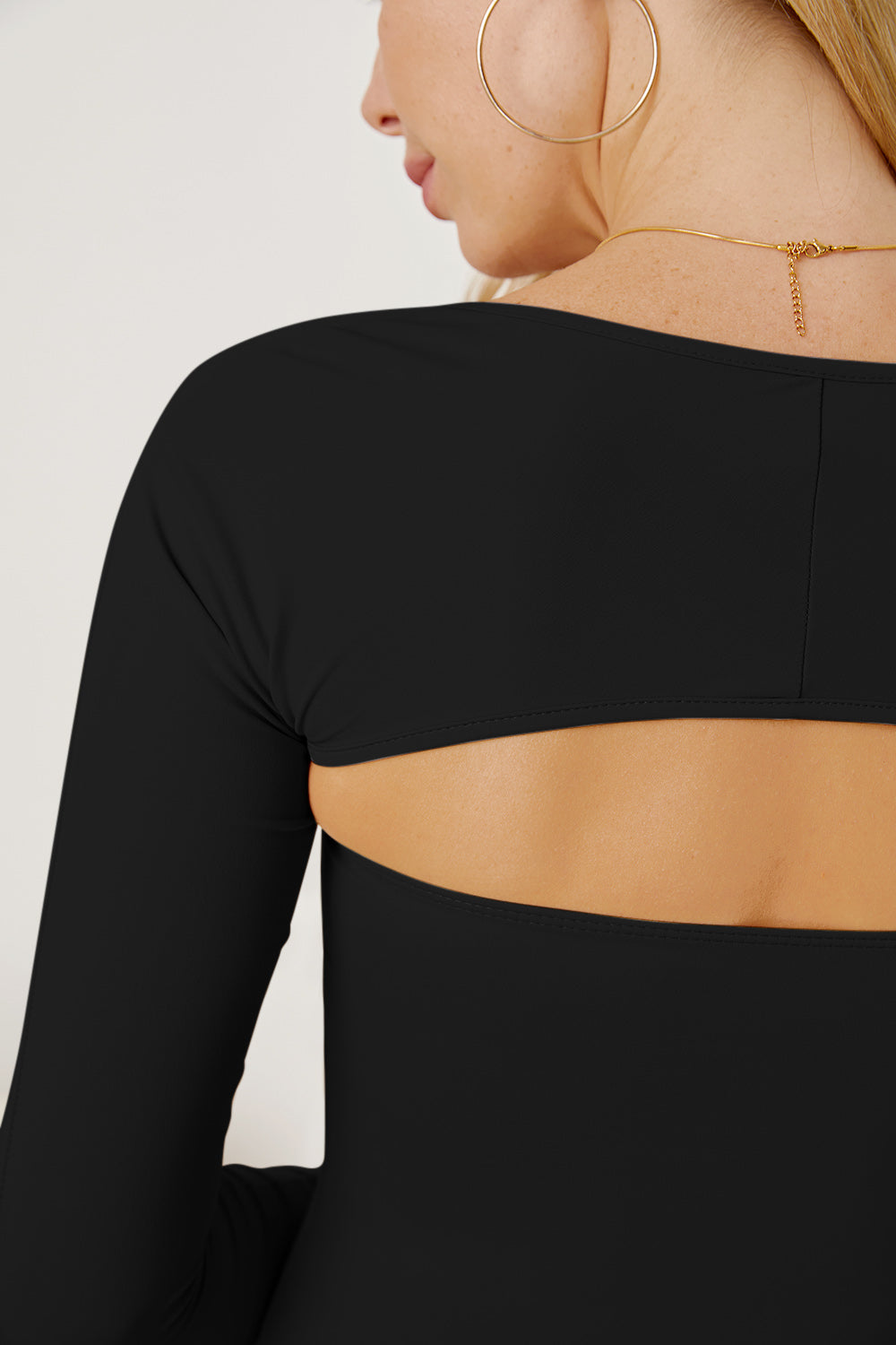 Black long sleeve bodysuit with open back detail
