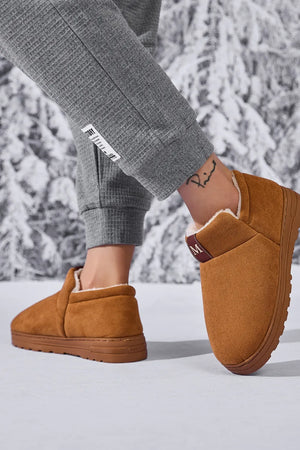 Caramel suede shearling-lined house booties with a burgundy accent tab.