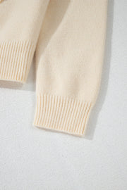 Ivory bouclé knit cardigan with ribbed cuffs and hem detail.