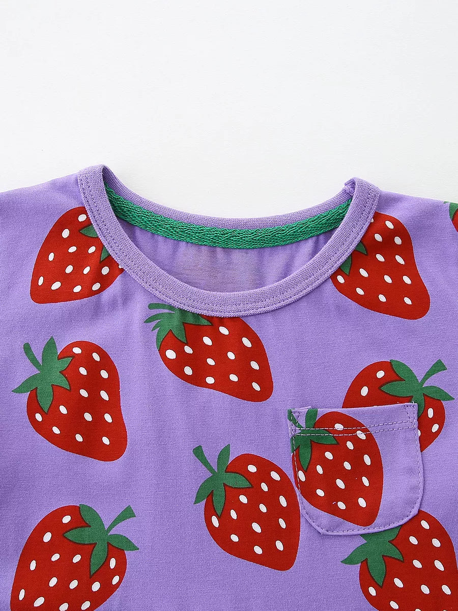 Purple toddler dress with allover red strawberry print and a chest pocket.