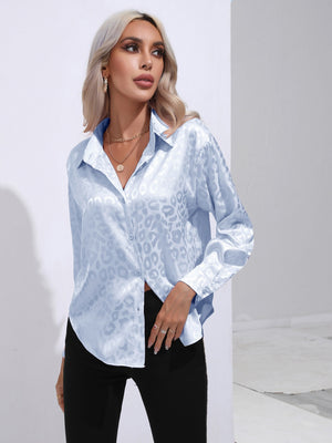 Light blue satin leopard print button-down shirt with a collared neckline and long sleeves.