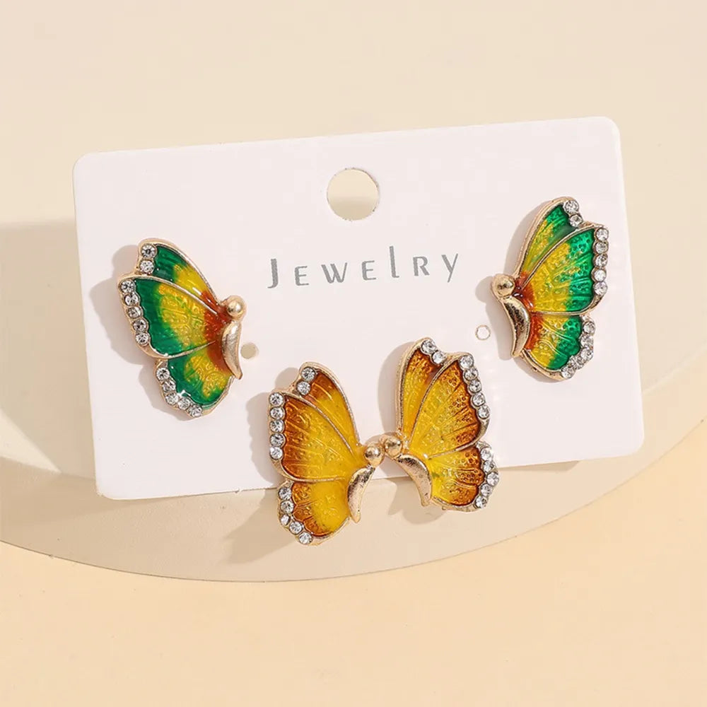 Enamel winged stud earrings with crystals in multicolor yellow and green butterfly design.