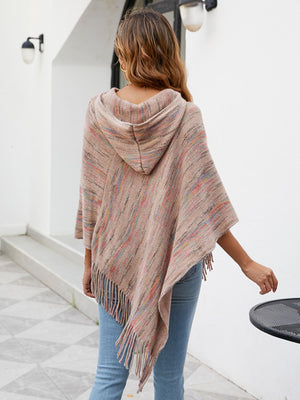 Hooded mélange cape in a neutral tone with colorful threads and fringe detail.