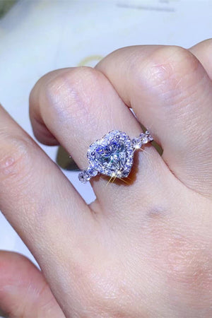 White moissanite halo engagement ring with heart-shaped center stone.
