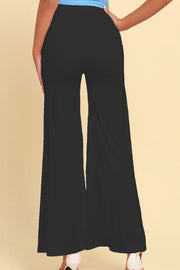 Black palazzo trousers with dramatic front slits and wide legs.