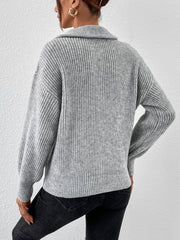 Gray ribbed zip-up sweater with a shawl collar and balloon sleeves.