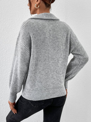 Gray ribbed zip-up sweater with a shawl collar and balloon sleeves.