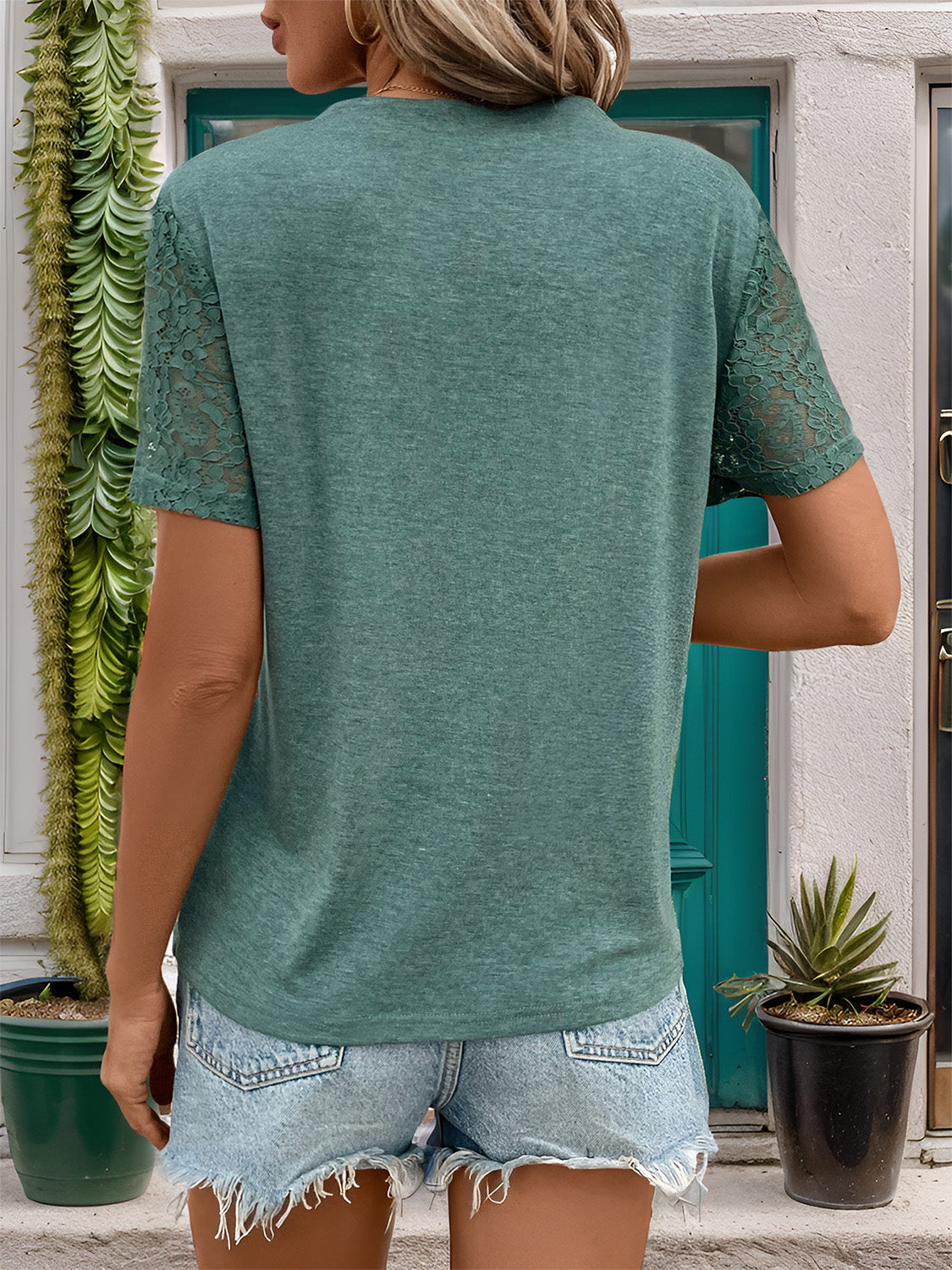 Green V-neck tee with lace short sleeves and a relaxed fit.