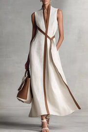 Belted midi dress in white with elegant brown contrast trim and a matching sash.