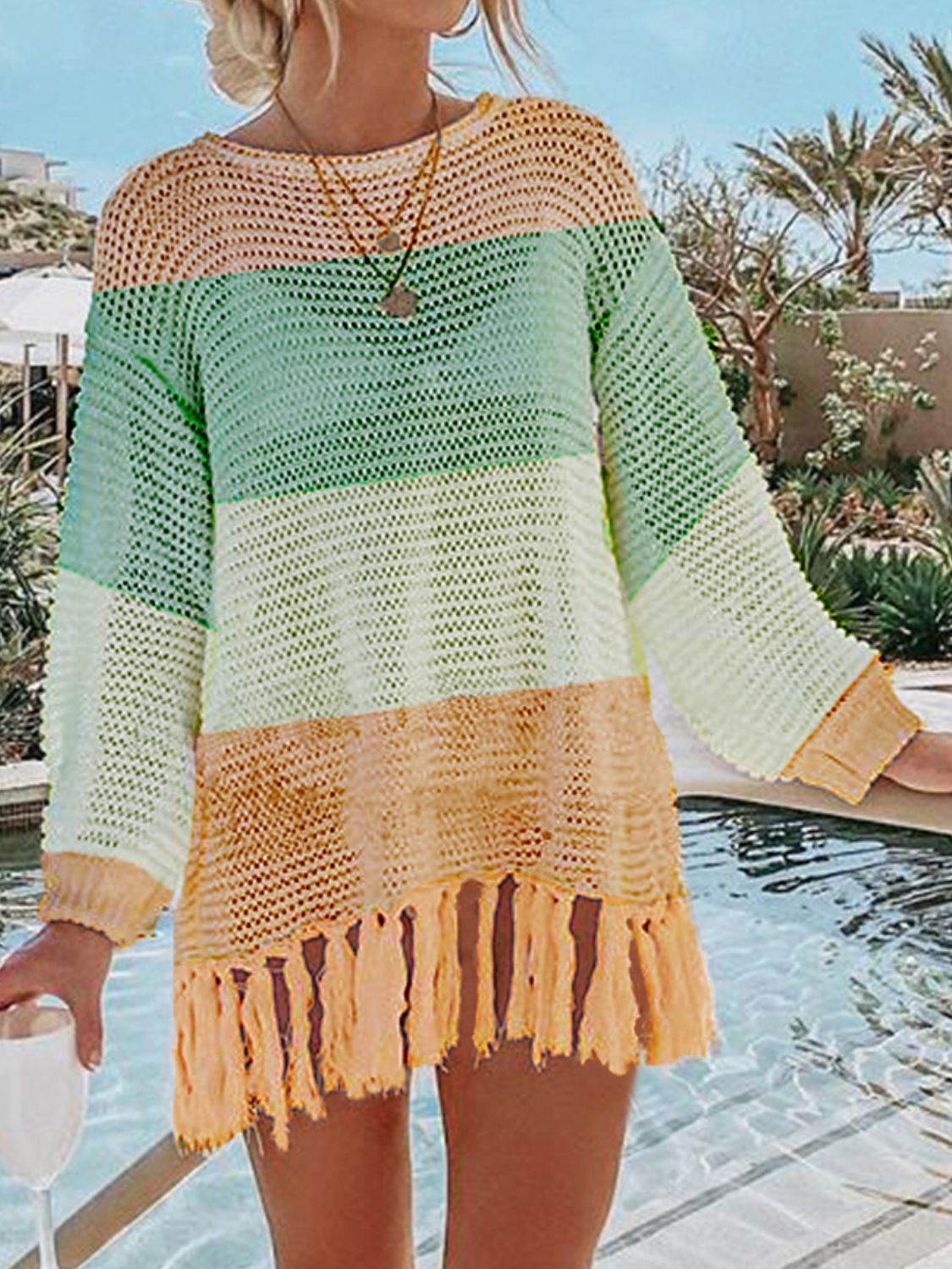 Open-knit beach cover-up with fringe detail in pastel stripes.