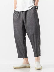 Men's dark gray relaxed fit cropped sweatpants with drawstring waist and pockets.