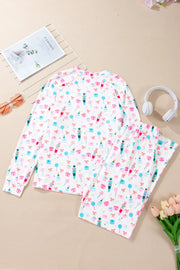 White pajama set with festive nutcracker, candy cane, and gift print.