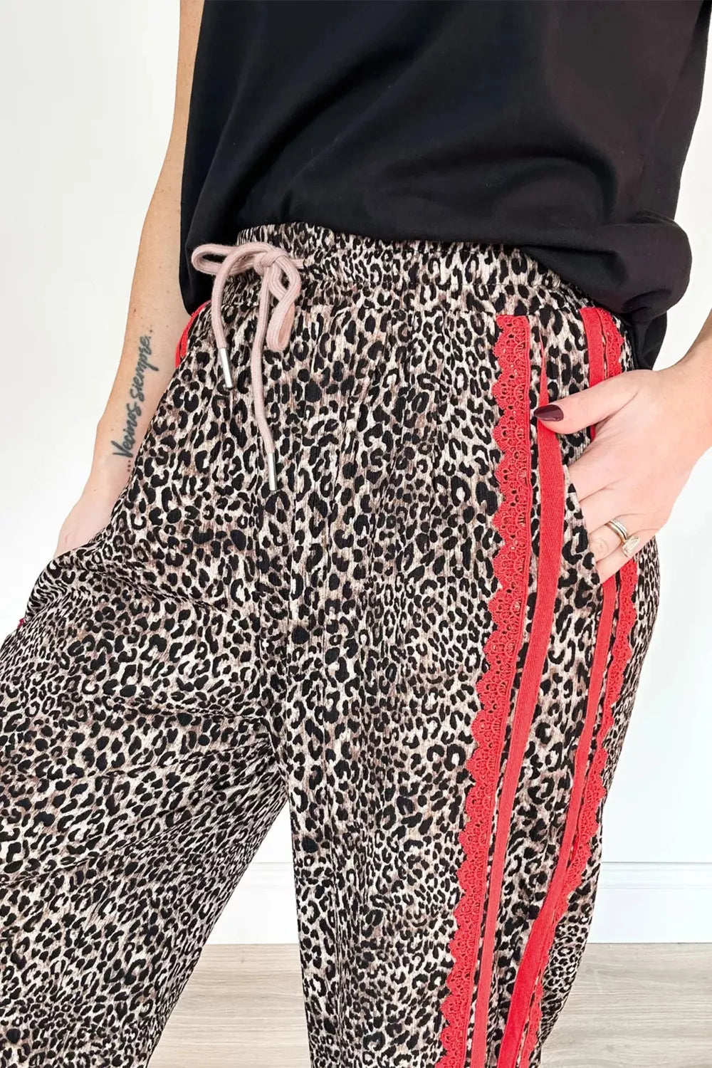 Maternity leopard print wide-leg pants with red lace trim and drawstring waist.