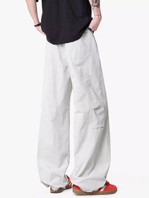 Lightweight wide-leg drawstring pants in light gray with cargo pockets.