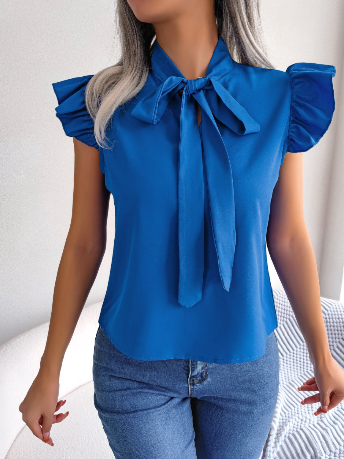 Cerulean ruffled sleeve pussybow blouse with a tie neck.