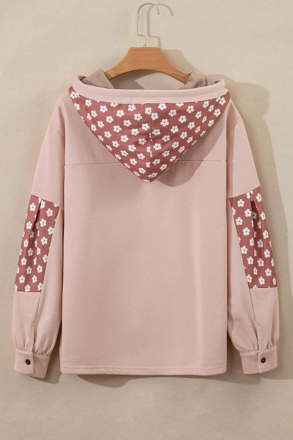Dusty pink hoodie with floral patchwork on the hood and sleeves, button cuffs.